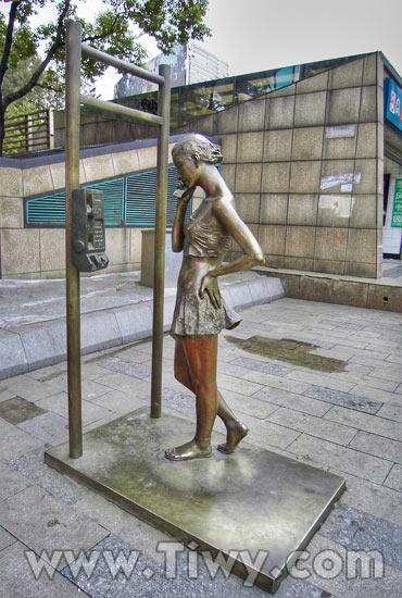 Sculpture — a girl and a telephone booth