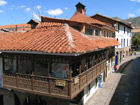 Red tiled roofs and jolly carved balconies